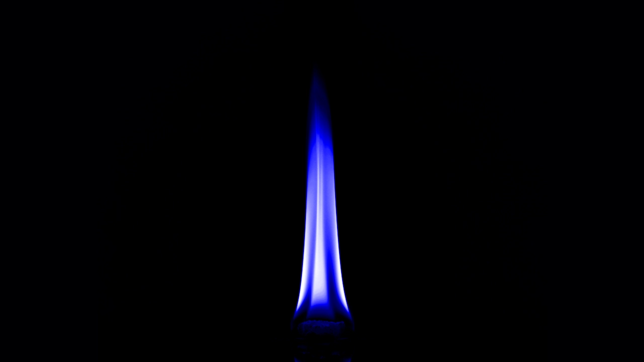 a blue flame on black background