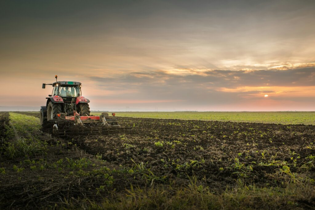 farm tractor in field; tilling soil