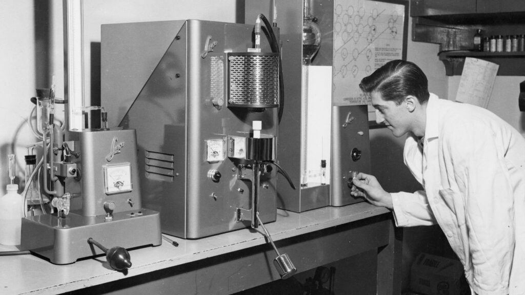 Scientist looking at scientific instrument