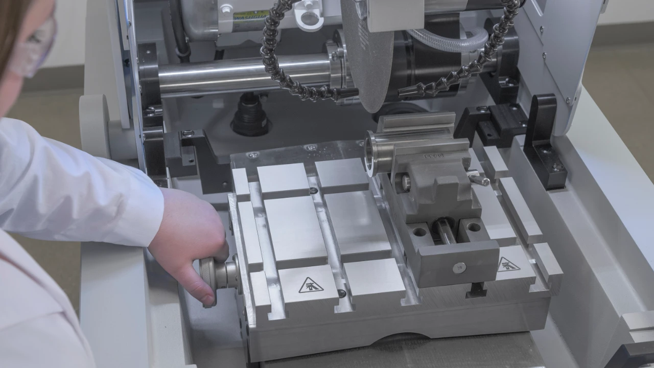 Metallurgist adjusting cutting table