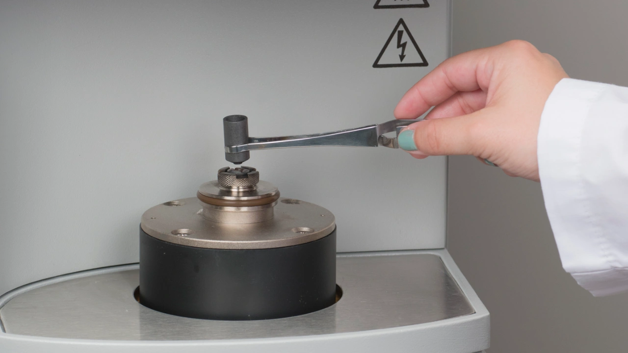 Scientist loading sample crucible into elemental analyzer