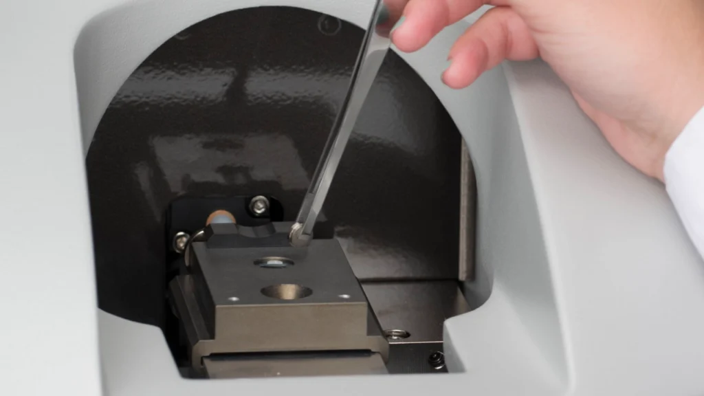 Scientist loading metal sample into elemental analyzer
