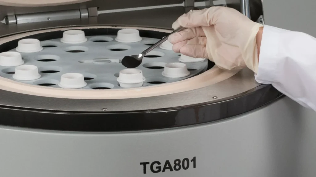 Scientist placing coal sample into TGA crucible