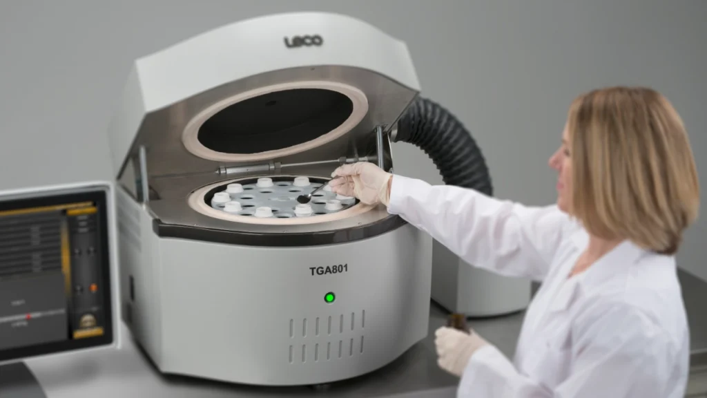 Scientist loading samples into thermogravimetric analyzer