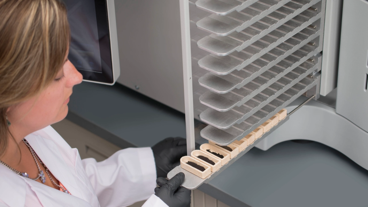Scientist loading LECO SC832 autoloader