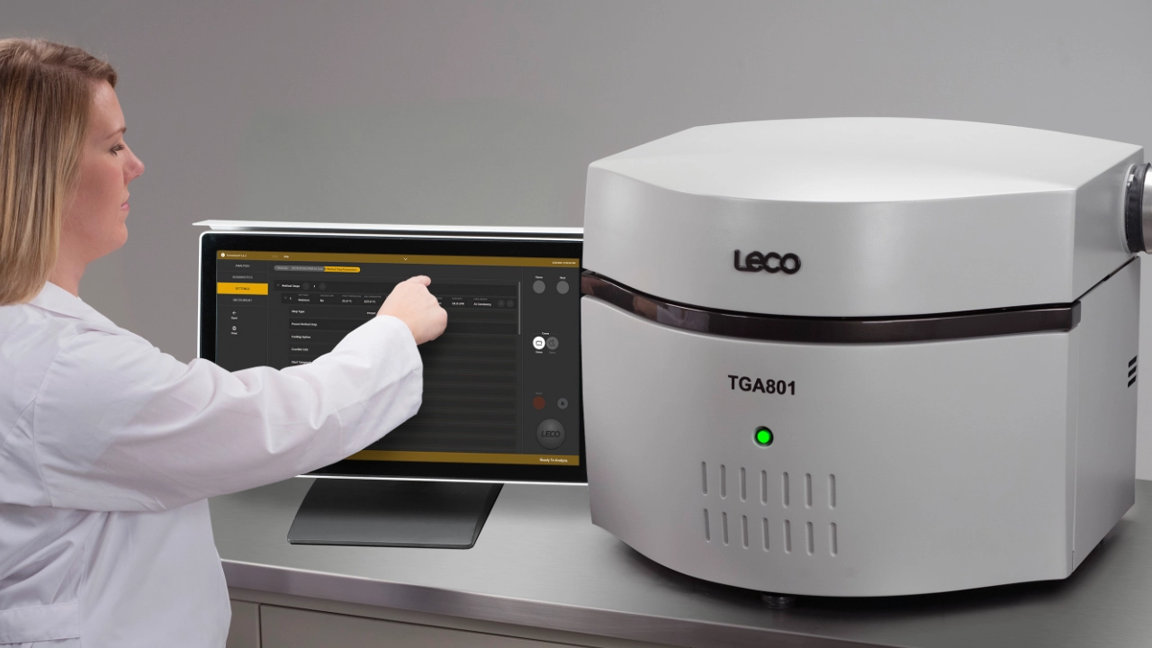 Scientist operating thermogravimetric analyzer