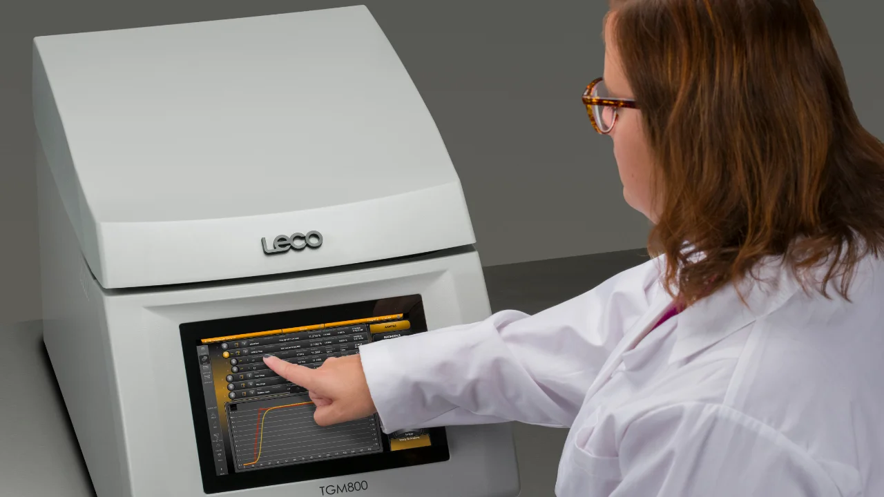Scientist operating thermogravimetric analyzer